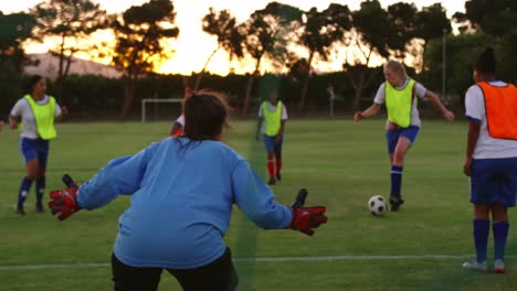 female soccer players passing the ball while female player falls down. 4k