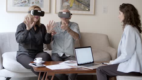 slow motion shot of agitated mature people experiencing vr glasses