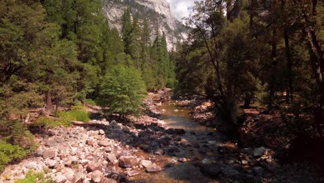 tilting down shot from rocky granite ridge to a flowing river