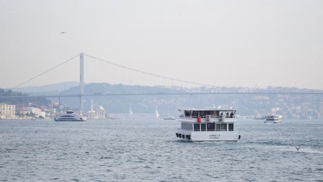 ferry in istanbul bosphorus with fatih sultan mehmet bridge