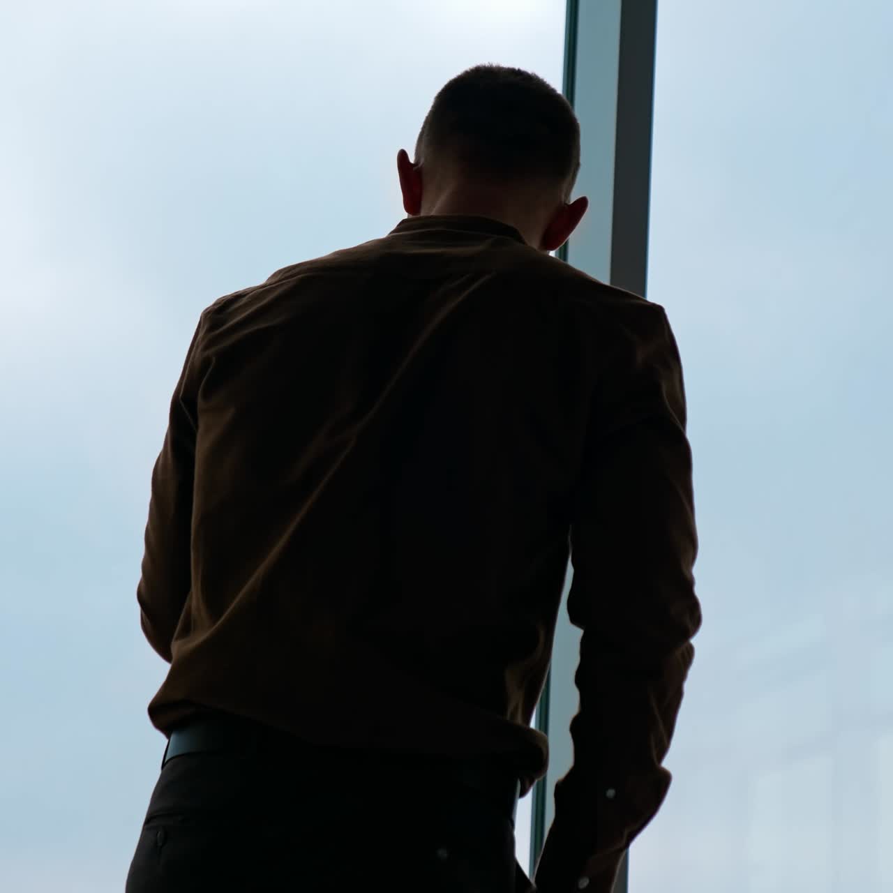 Businessman standing in his office. Business District Panoramic Window View