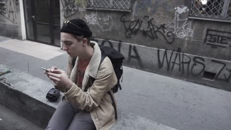 young traveller checking his mobile messages. wide shot