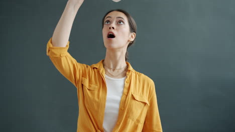 woman holding a 'like & subscribe' sign