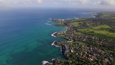 high angle sweeping aerial view of kahana maui coastline and communities overlooking ocean reef