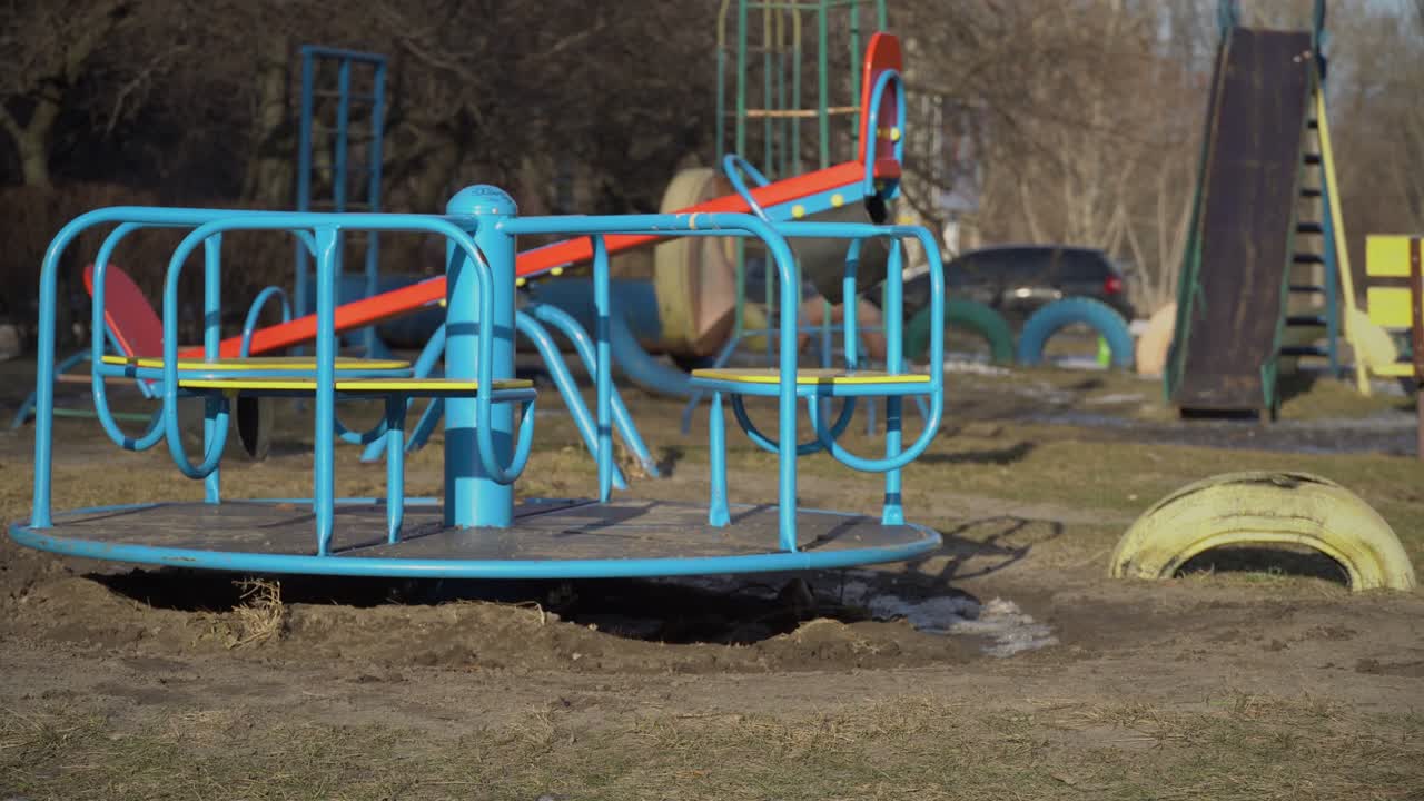 Empty Swing is Spinning on the Playground in the Yard