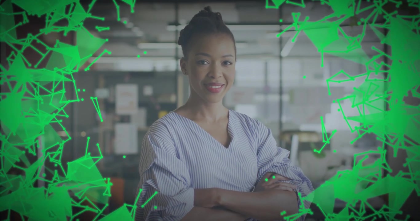 Professional woman standing in office, green shapes moving from edges enveloping her with data mesh