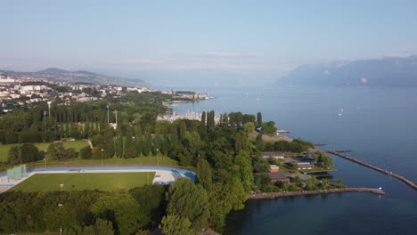 slow rising aerial shot of a harbor along lake geneva in laussane, switzerland