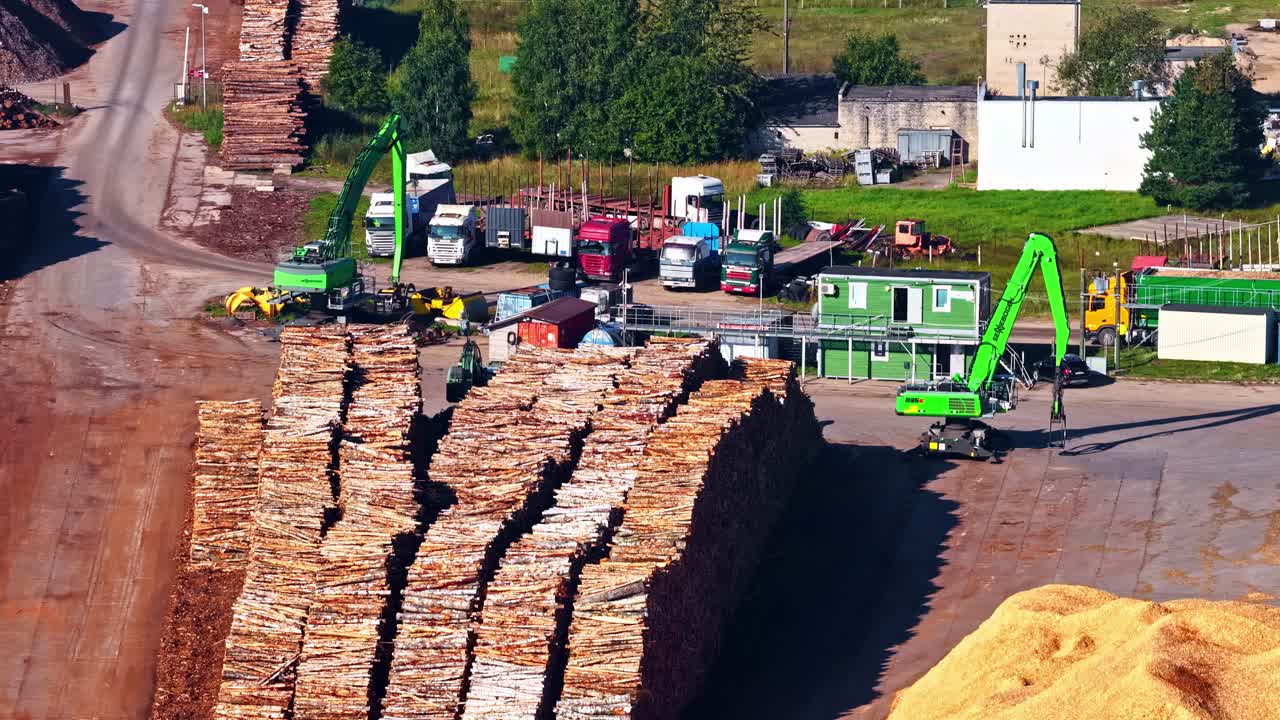 Lumberyard with stacks of timber, machinery, and workers under sunny skies