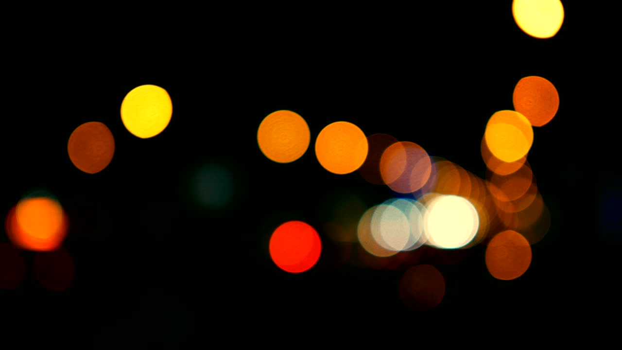 Defocused lights Los Angeles street abstract . City blur background. Moving bokeh circles of night traffic.