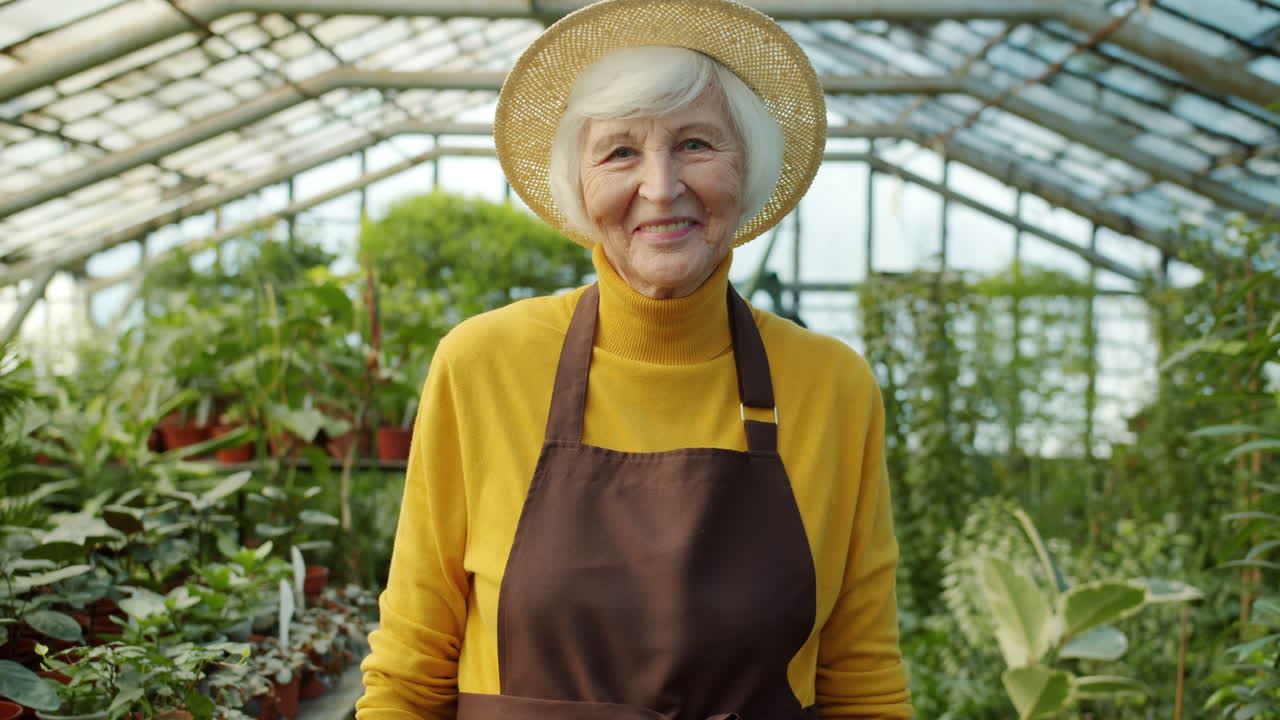 Smiling Gardener in Greenhouse