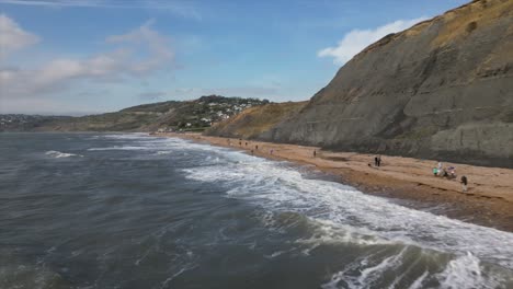 beach goers enjoying the beautiful scenery of the charmouth beach