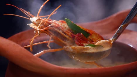 Steaming-hot-shrimp-soup-served-in-a-traditional-clay-pot,-capturing-the-essence-of-Thai-cuisine,-Close-Up