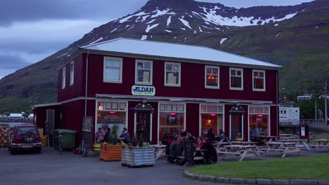 diners eat and drink at a local pub in seydisfjordur iceland