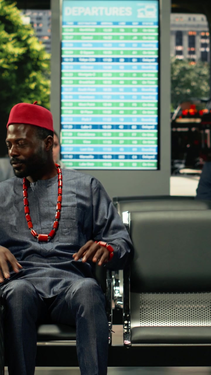 African American man traveling solo in crowded bus terminal
