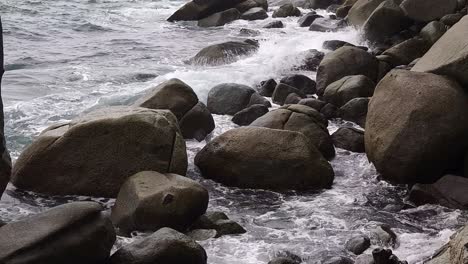 ocean waves crashing against rocks on a coastline