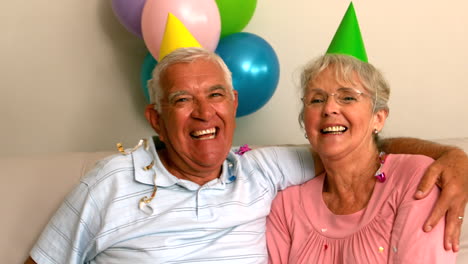 senior couple celebrating a birthday on the couch