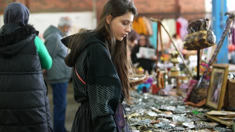 young woman browsing at a flea market