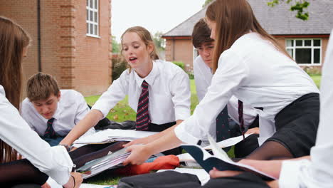 teenage students in uniform working on project outdoors