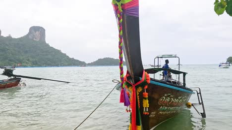 barcos anclados por escénicos acantilados y exuberante vegetación
