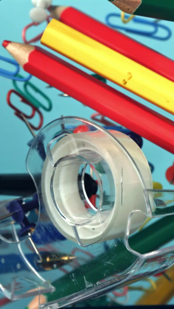 Colorful Office and School Supplies with Tape Dispenser on Blue Background