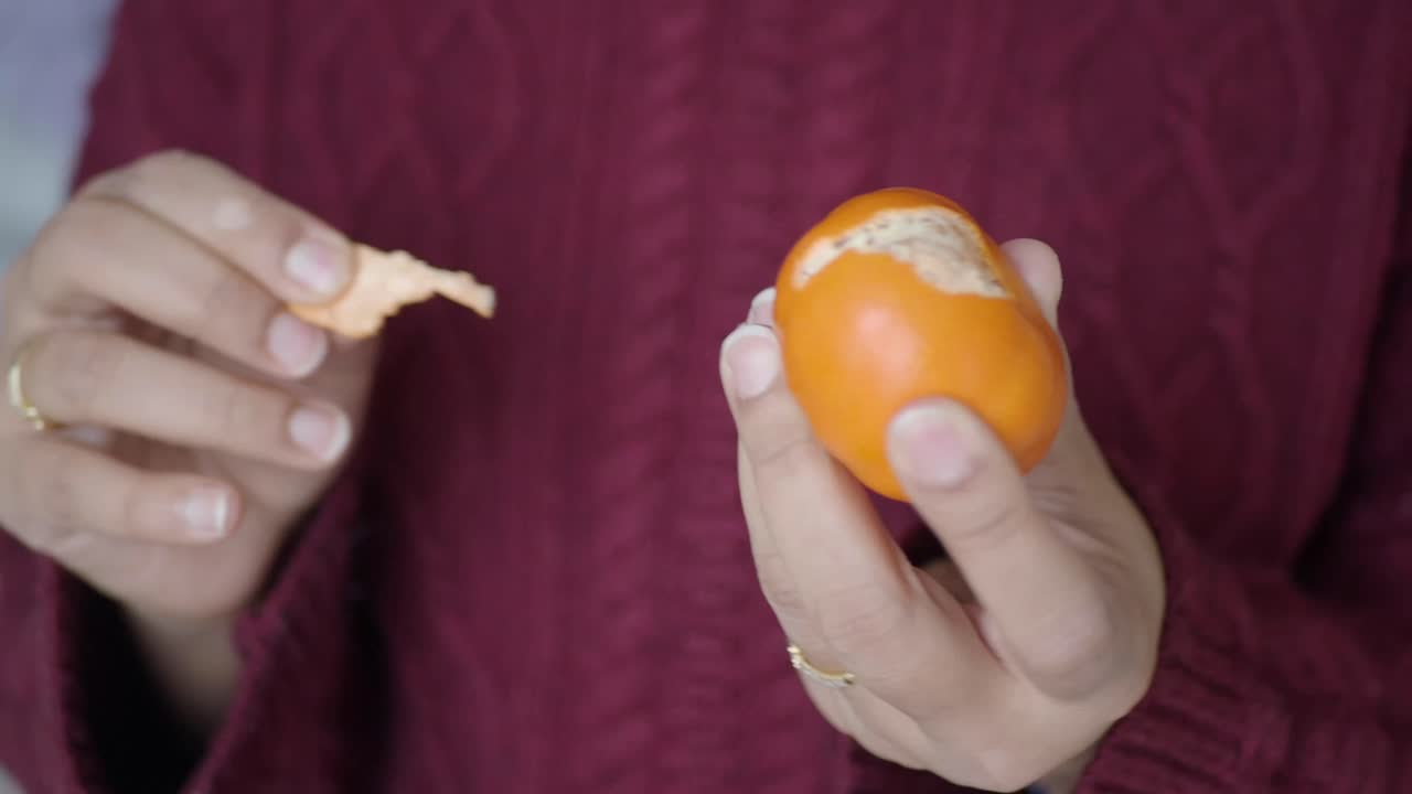 Peeling a mandarin orange