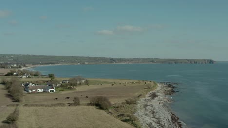 aerial establishing shot along sea coast at day in summer, wide angle