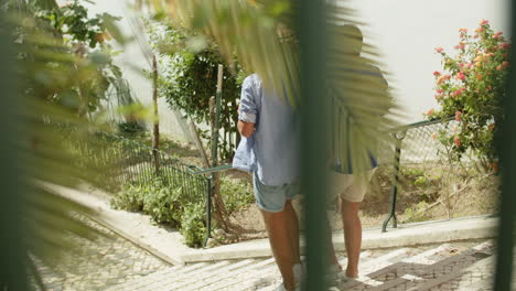 tracking shot of gay couple descending stairs in public park and hugging