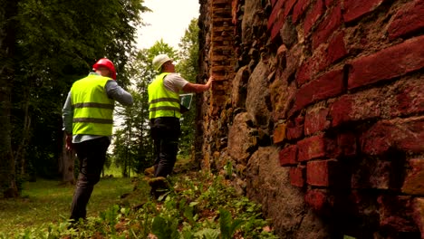 engineers near old brick wall