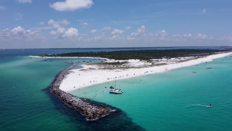 Aerial-shot-of-rocks,-clear-green-and-blue-water-of-Shell-island