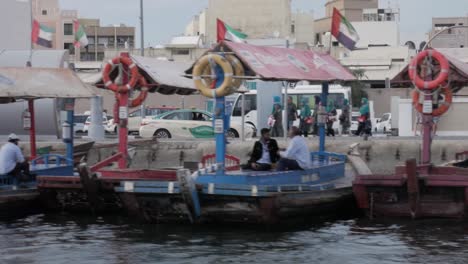 boat taxi transport dubai deira with waiting immigrants, moving shot