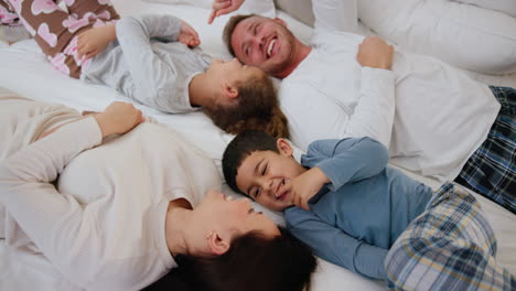 top view, tickle and happy family in a bed