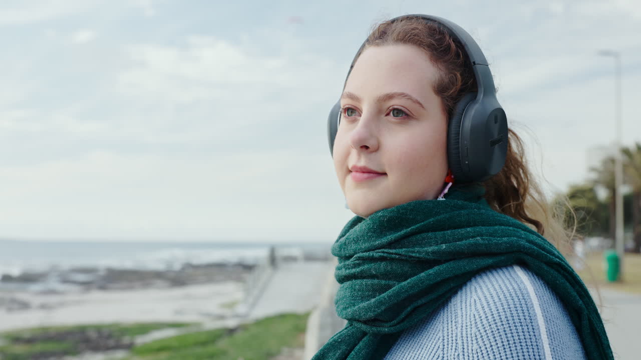 Woman wearing headphones on beach