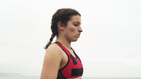 smiling pensive female triathlete enjoying jogging