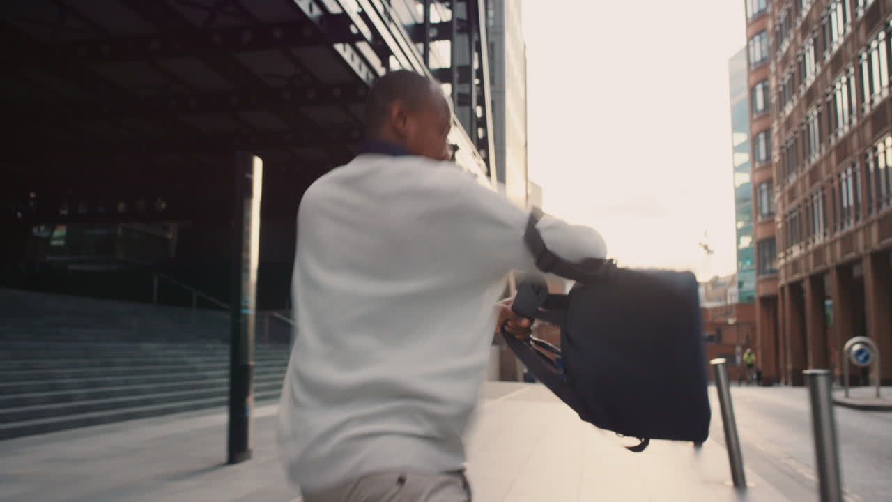 African American Businessman in trouble running away from danger