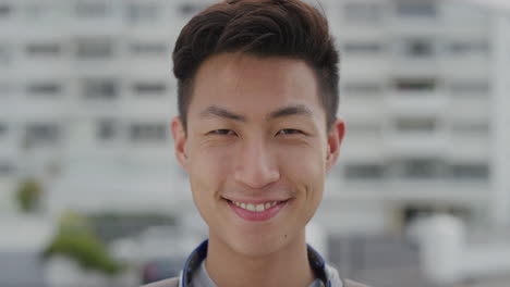 close up portrait happy young asian man tourist smiling enjoying summer vacation independent teenage male looking cheerful real people series