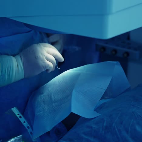eye surgery on patient. surgeon performing eye procedure on patient in hospital
