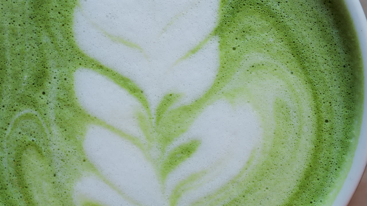 Close up of a matcha latte on a wooden table