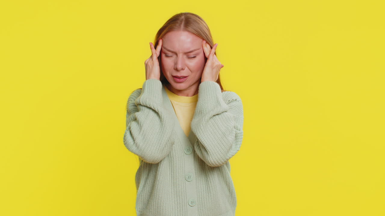 Woman rubbing temples to cure headache problem suffering from tension and migraine stress pain