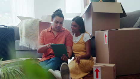 happy couple on floor of new house with boxes