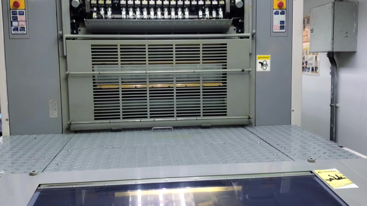Industrial offset printing press machine in a print shop factory