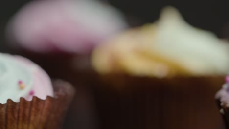 extreme close up of cupcakes orbiting around central cupcake