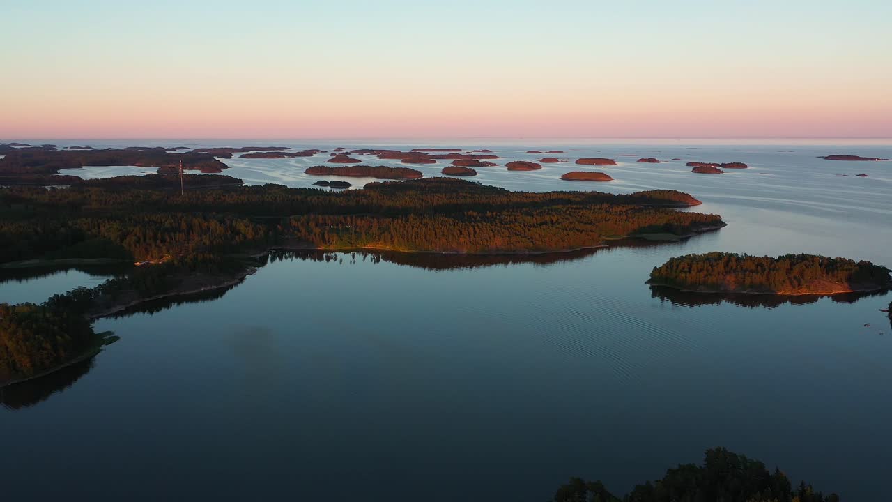 Drone shot of sunlit saaristo islands, serene, summer evening, in the Tammisaari archipelago, Raasepori, Finland - tracking, aerial view