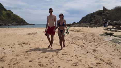 couple snorkeling on a tropical beach