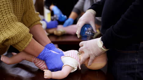 instructor showing cpr on training doll. woman performing cpr on baby training doll