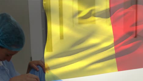 Digital-composition-of-belgium-flag-waving-against-stressed-female-health-worker-at-hospital