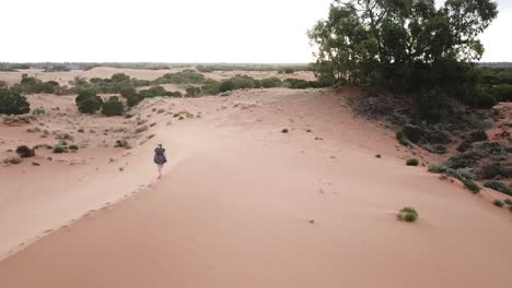 Outdoor-nature-drone-aerial-over-woman-sand-hills-summer-australia-dancing-hat-off