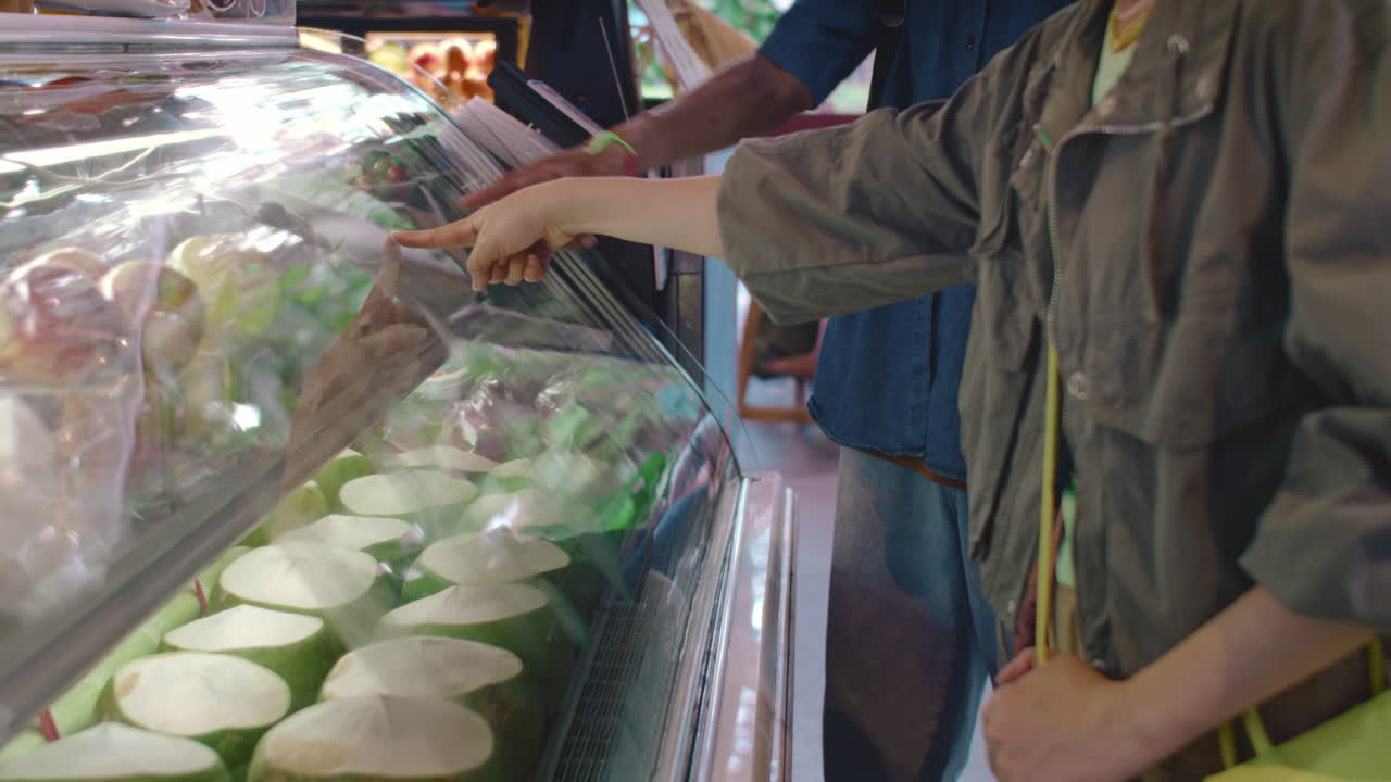 Couple Choosing Fresh Fruits Standing next to Market Stall
