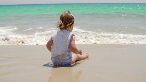 Cute-young-girl-paddling-in-the-surf