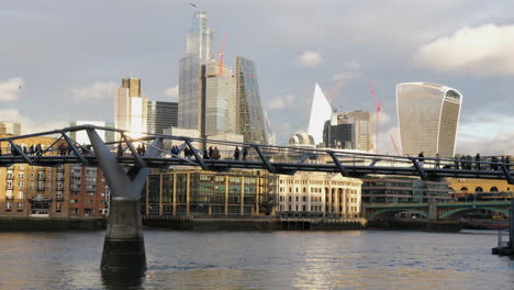 slomo static shot of unrecognizable people walking on london millennium bridge