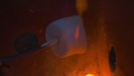 Close-up,-roasting-a-marshmallow-over-an-open-flame